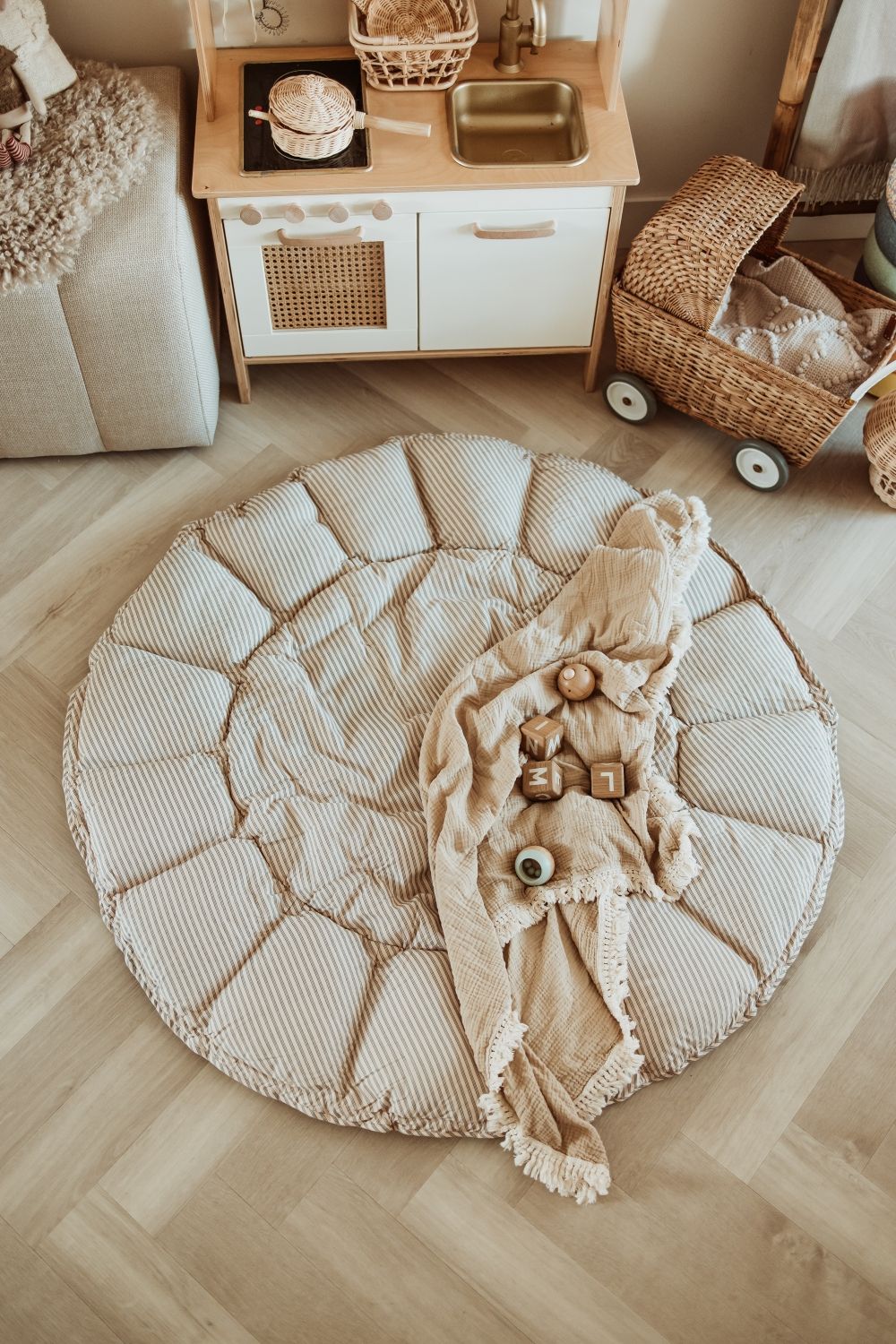 bloom stripes blue babymat, open on floor in kidsroom, blanket and wooden toys, kitchen and stroller