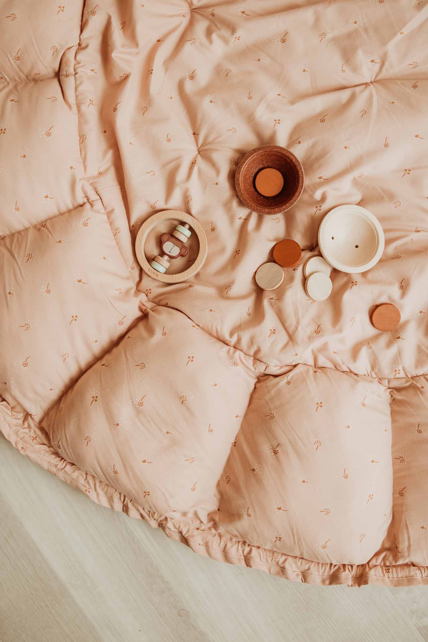 Bloom fleuri organic babymat, toys lying on open mat