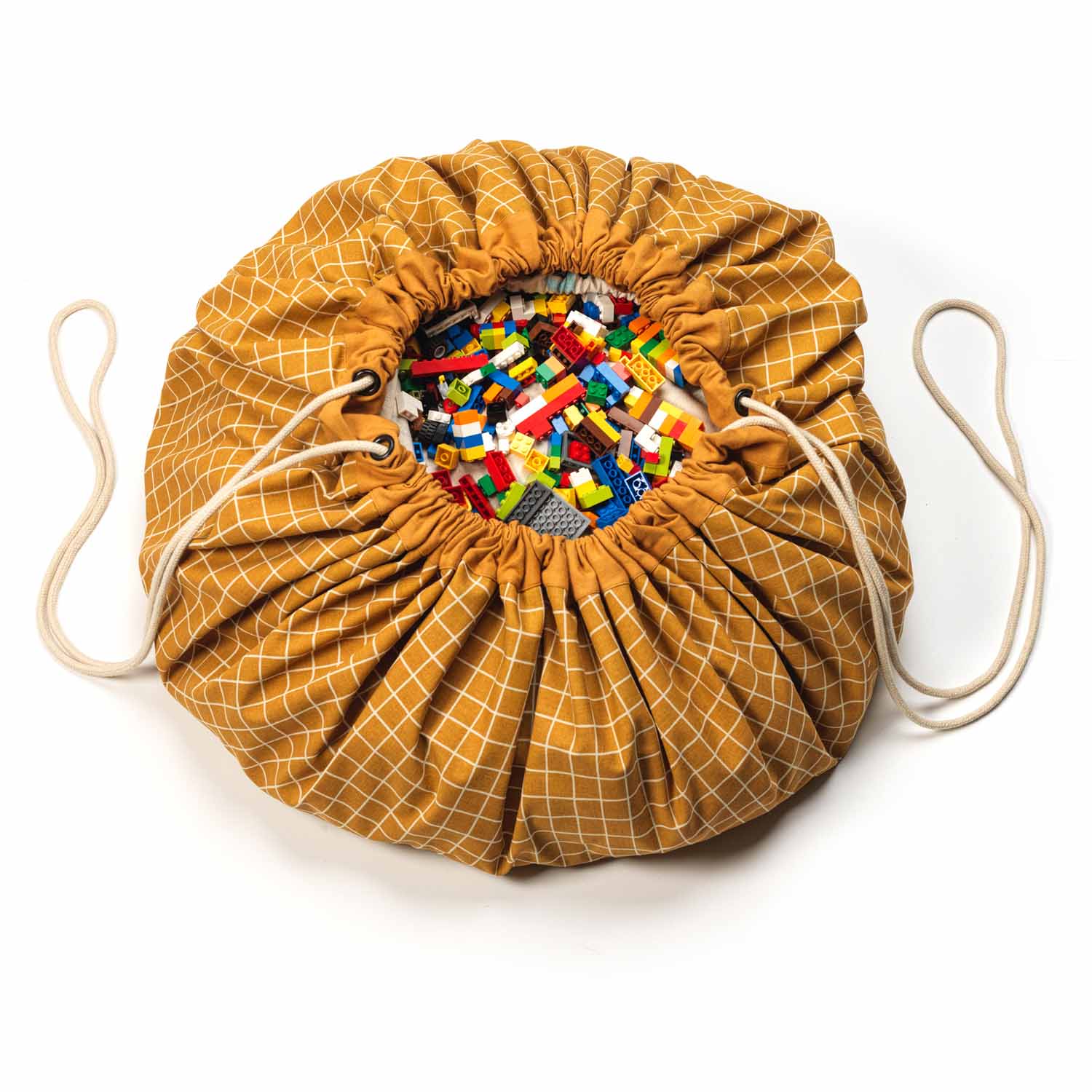 organic grid mustard storage bag, filled with toys