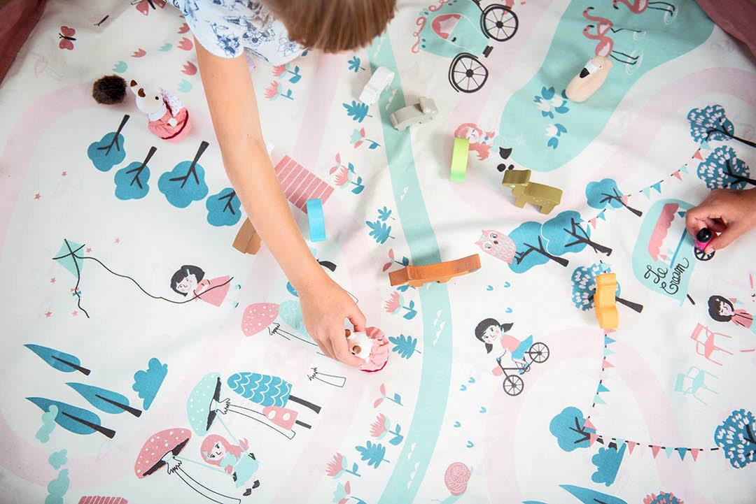 Walk in a Park toy storage bag and play mat, kids playing with wooden animal toys