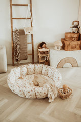 bloom rabbit babymat, crib, raised edges, blanket and wooden baskets in kidsroom
