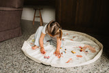 fairyworld toy storage bag and playmat, child is playing on the mat with wooden toys