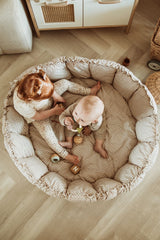 bloom stripes blue babymat, crib, raised edges, baby and toddler are sitting and playing in the crib
