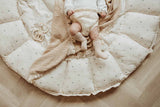 Bloom moon organic babymat, baby lying on open mat on blanket