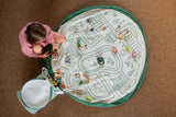 soo roadmap, open basket and open mat, lots of wooden toys, child is playing with the toys