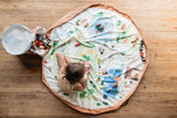 soo zoo, open basket and open mat, lots of toys, child is sitting on the mat and playing