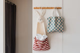 toto bunny, hanging on coat rack, filled with towels, toto dino transformed into a bag