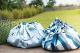 outdoor storage bags blue/green stripes and little boat print, closed bags standing next to each other on terrace in garden