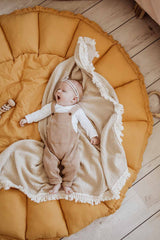 Bloom mustard organic babymat, little baby lying on open mat, on little white blanker