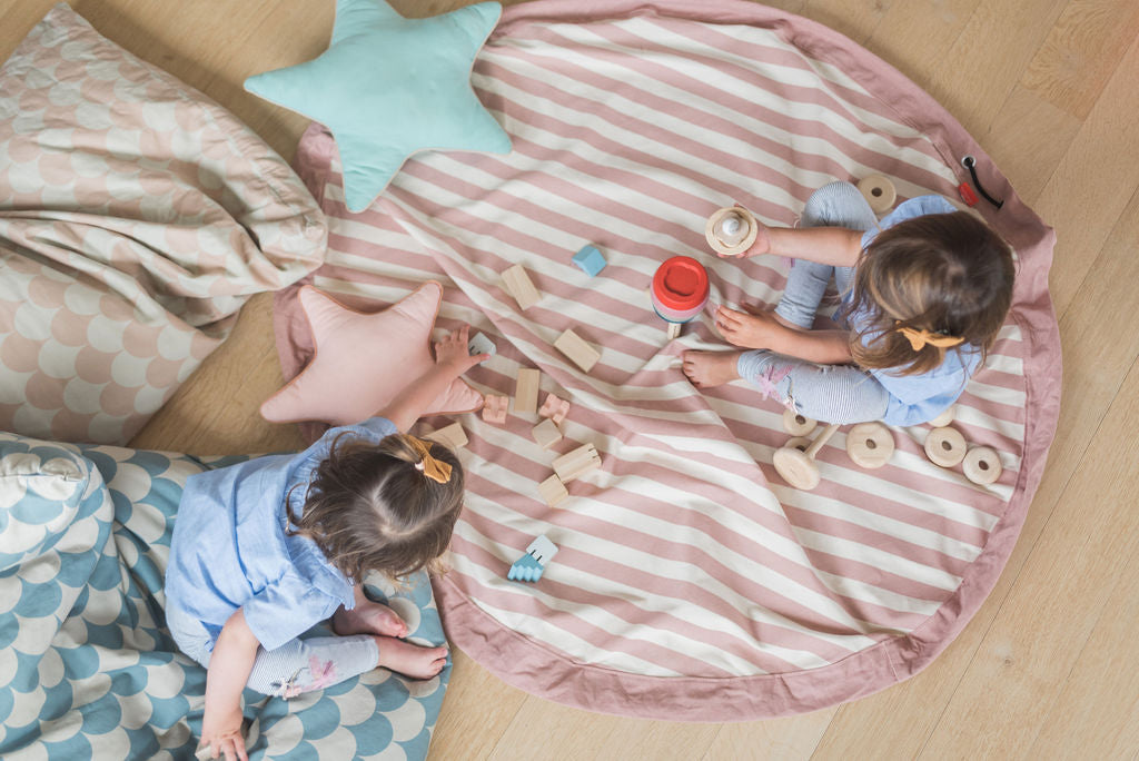 Stripes Pink New toy storage bag, children playing on mat with wooden toys, star pillows on the mat