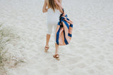 Play&Go outdoor storage bag and play mat, mokka stripes, girl carrying the bag while walking