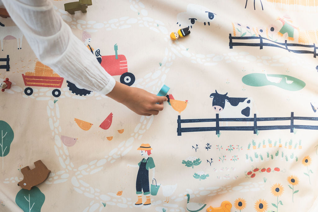 farm storage bag and playmat, child playing with wooden animals