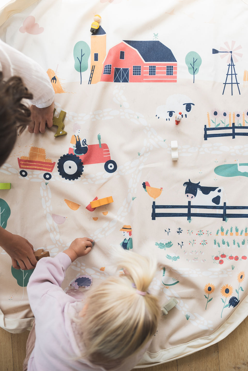 farm storage bag, children playing on mat with wooden toys