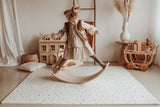 child playing with wooden slide on terrazzo puzzlemat in kidsroom