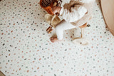child riding with tricycle on terrazzo puzzlemat