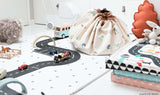 Play&Go storage bag and play mat, print big cars, closed, kidsroom, standing on floor between toys