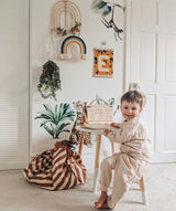 Play&Go toystorage bag and play mat, bag on floor, next to wall and little table, child playing